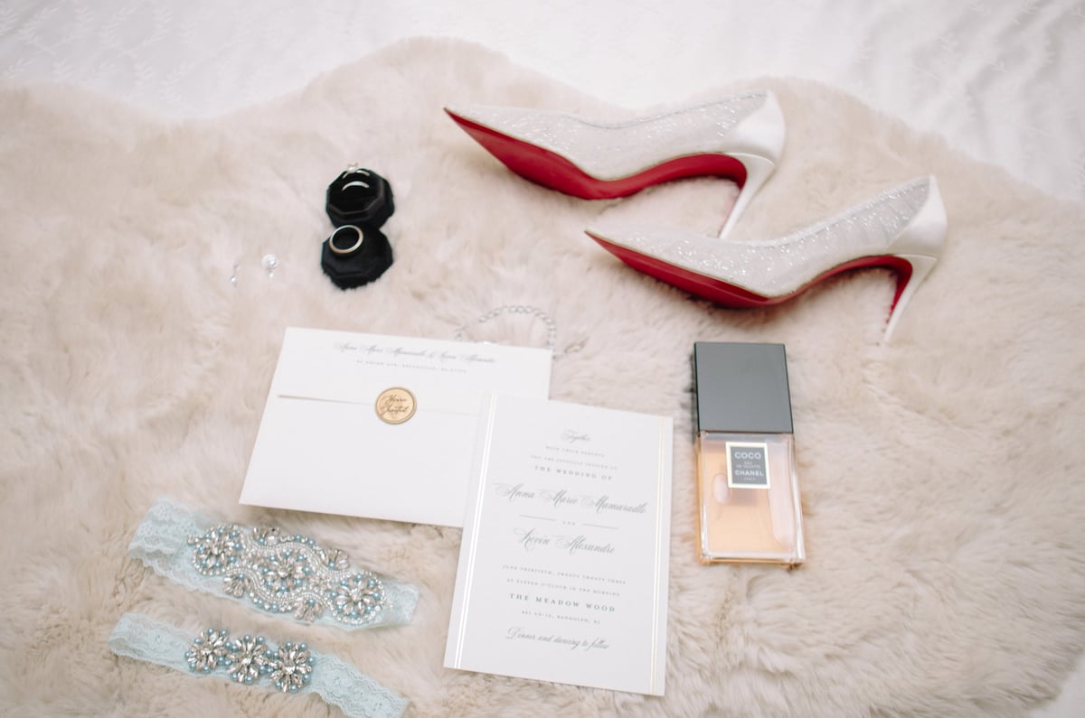 Wedding detail flat lay including rings and florals photographed by NJ wedding photographer Graison
