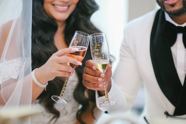 Bride and groom toasting with champagne flutes at wedding celebration